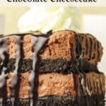 A stack of no-bake chocolate cheesecake bars topped with whipped cream and drizzled with chocolate sauce, shown up close with visible Oreo crust layers.